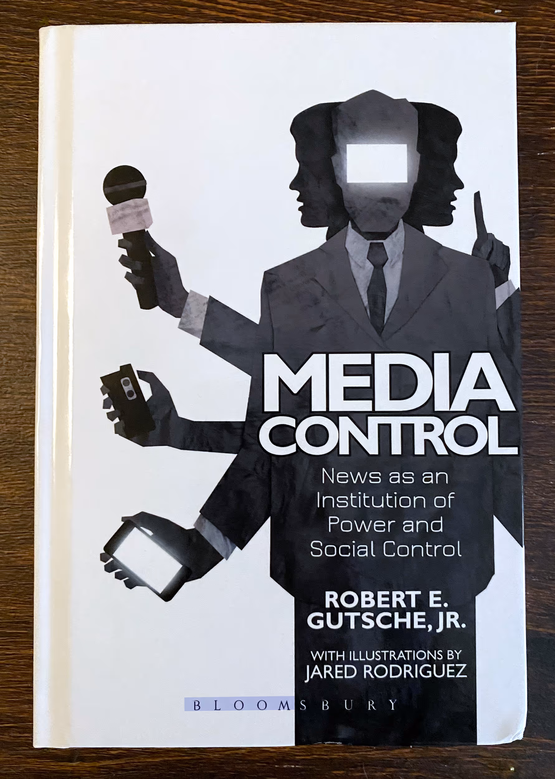Cover to Media Control, featuring an illustration of a multi-armed news media figure with a blank TV face.